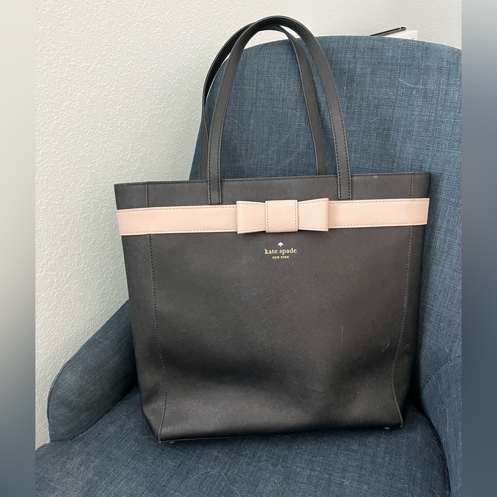Very very good used condition Kate Spade tote. Black with tan bow detail